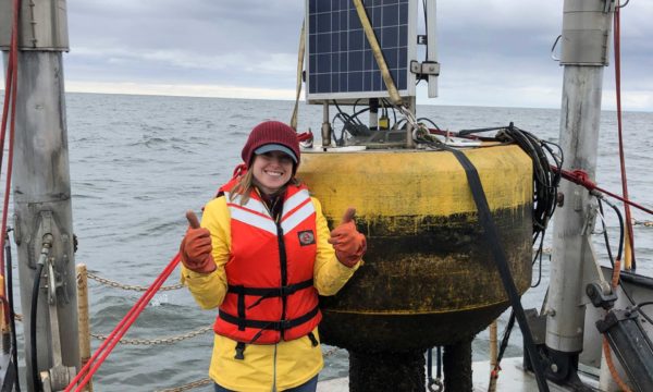 Woman gives a thumbs up as she is recovering the buoy at South Green Bay