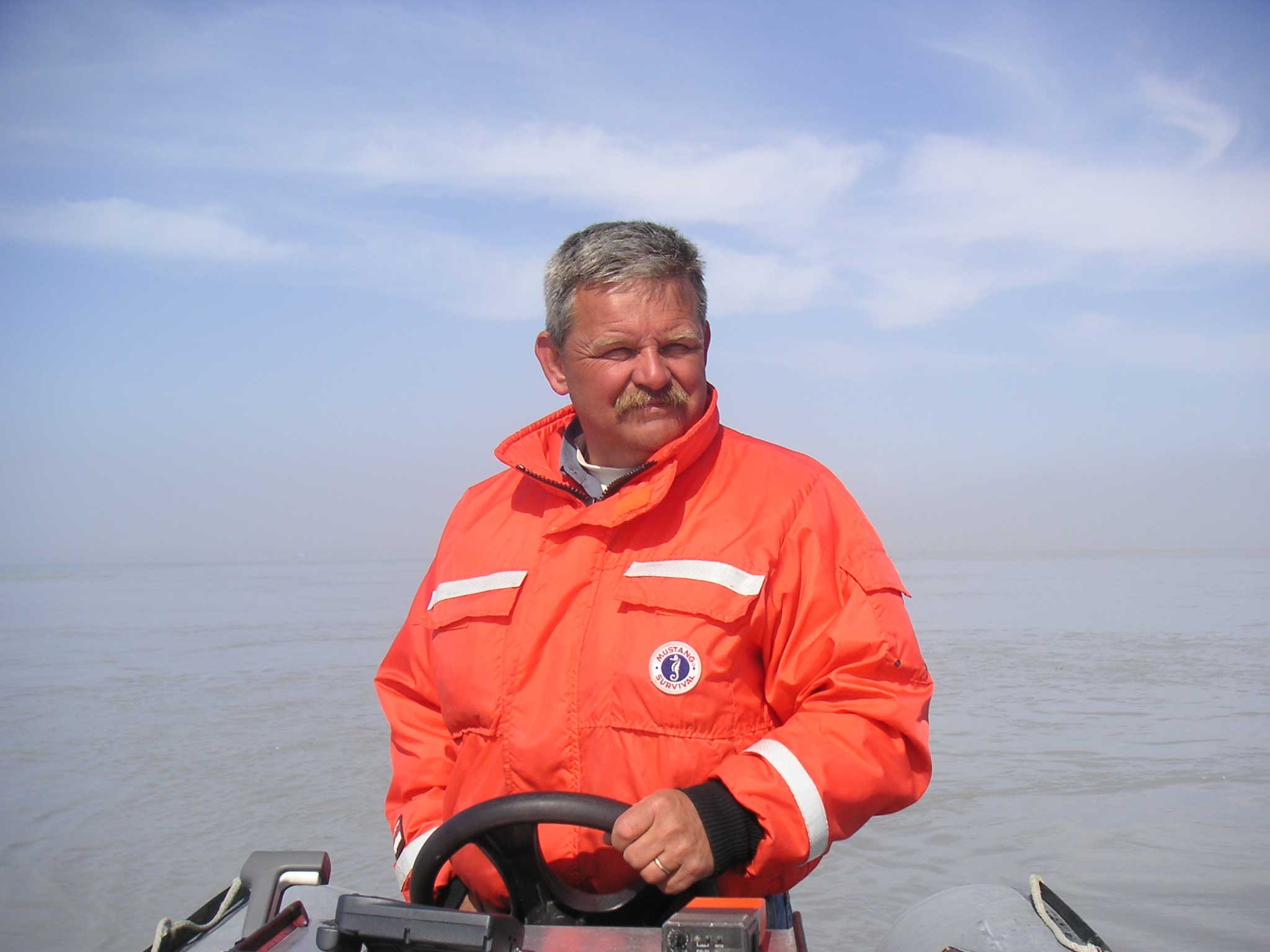 Guy Meadows steering a boat