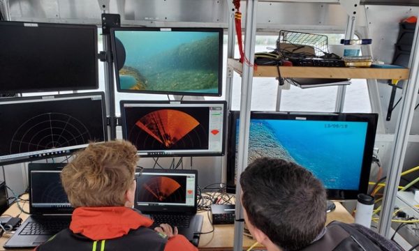 Two researchers look at screens during an underwater scanning mission_PC Ed Bailey, Northwestern Michigan College