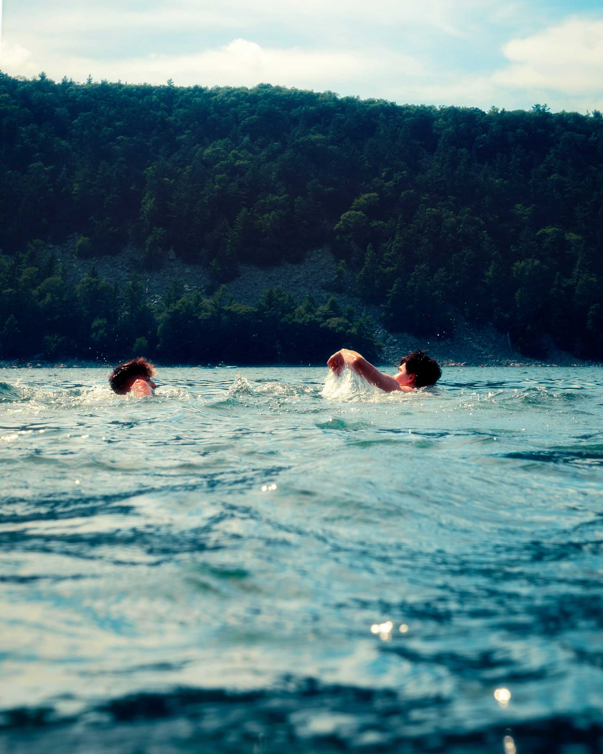 Two people swimming in the lake