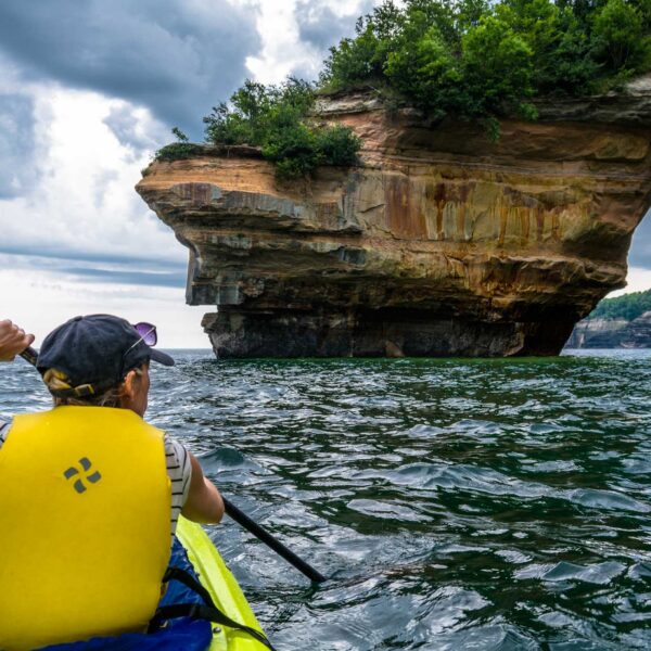 Kayaking near pictured rocks Woman kayaking near pictured rocks