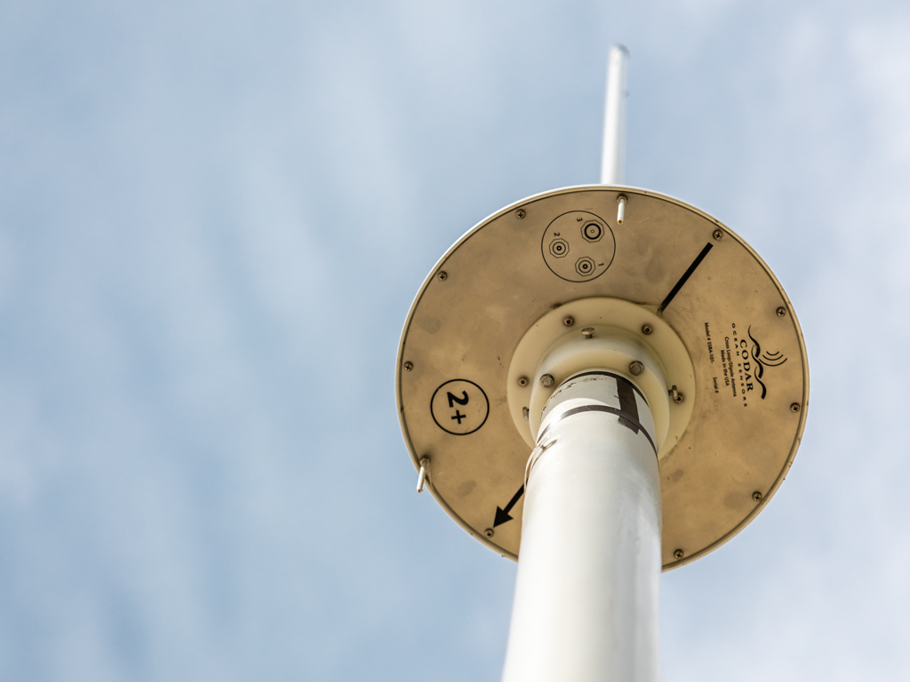 The underside of the high-frequency radar showing a white disk on a pole.