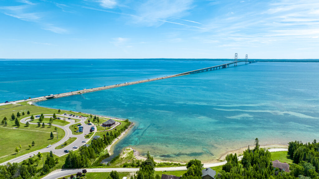 An aerial view of a park and the Mackinac Bridge. 
