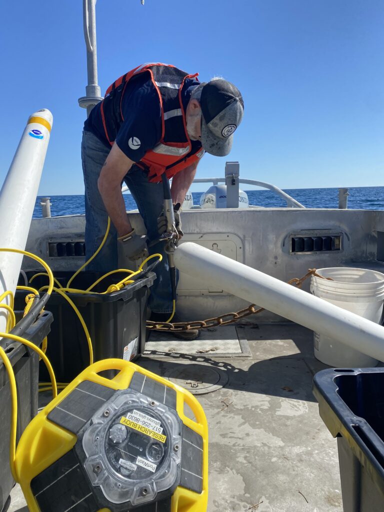preparing a spotter buoy for deployment on boat